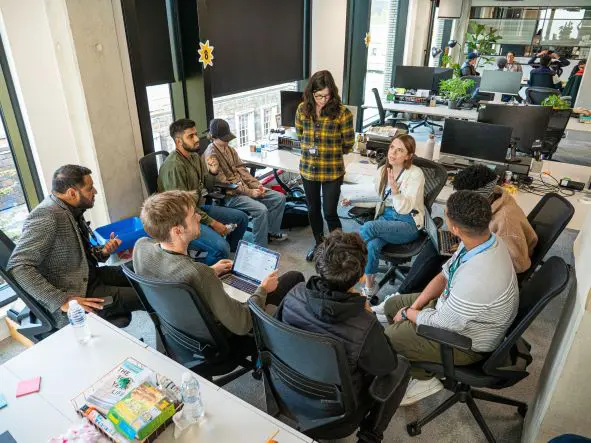 A group of people in discussion sitting in a circle at the workshop