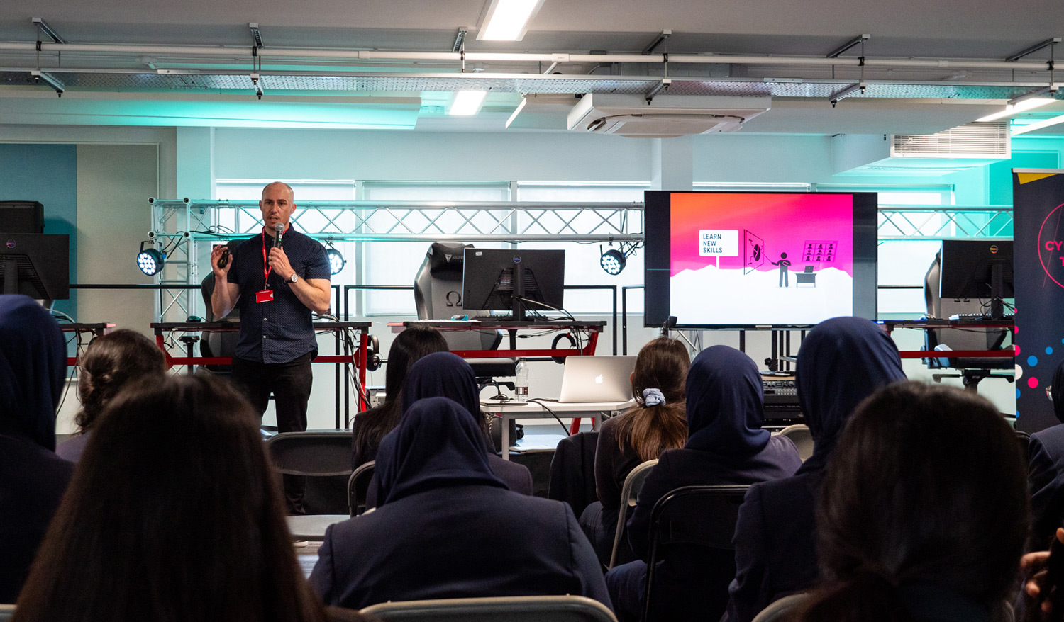 Photo of Garth Jemmett speaking in front of a crowd of young people