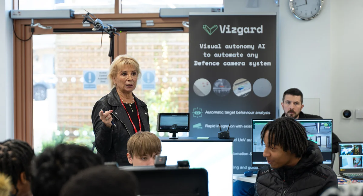 Students watching a drone flying in a classroom environment